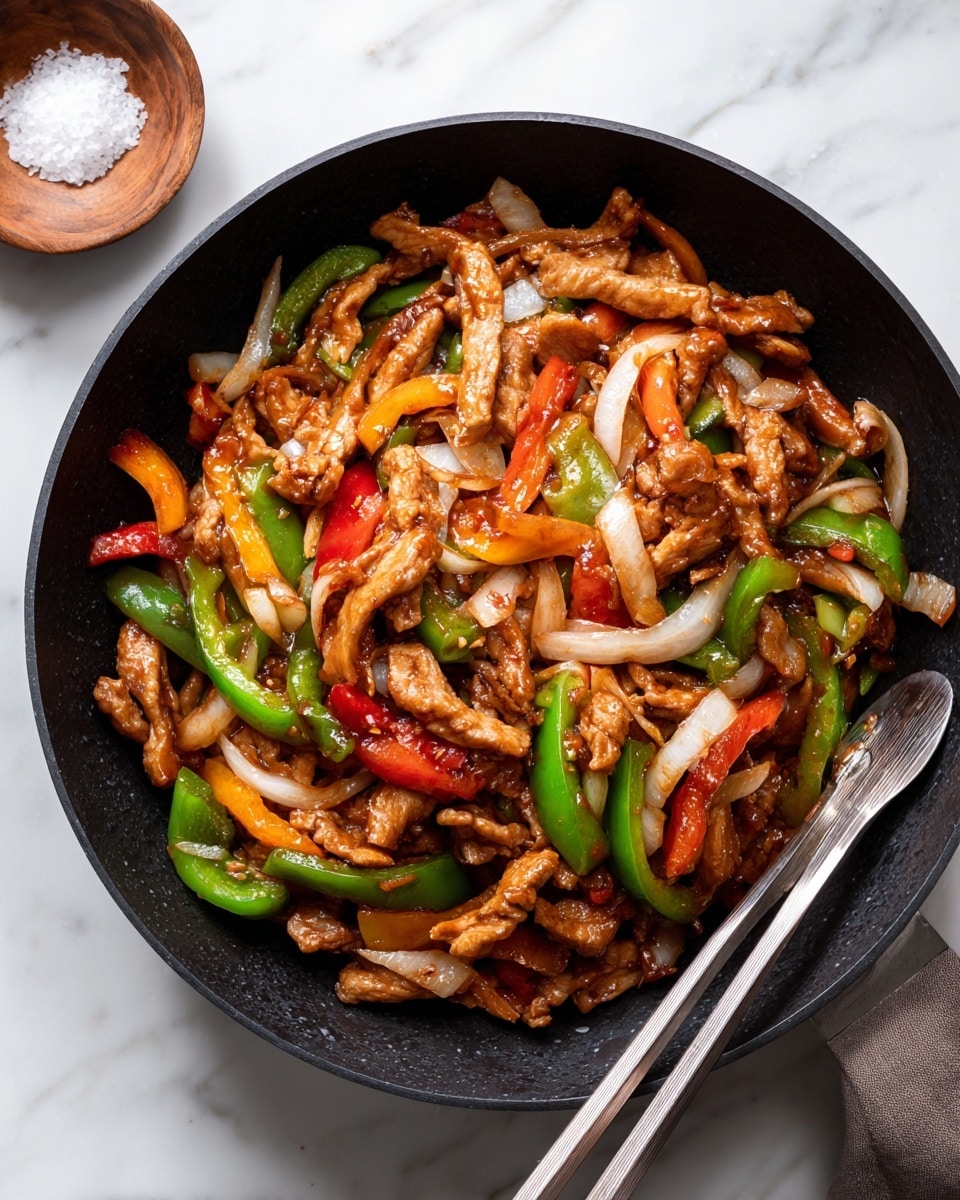 The image shows a black pan filled with a colorful stir-fry dish. There are three main layers: the first layer consists of red and green bell pepper pieces, the second layer is made of light brown, sliced cooked chicken with a glossy texture, and the third layer includes long, white, slightly translucent onion strips scattered evenly. The ingredients appear well mixed and coated with a shiny sauce. Two silver chopsticks rest on the edge of the pan near the bottom left. The background surface has a white marbled texture, and a small wooden bowl with coarse salt is seen near the top left corner. photo taken with an iphone --ar 4:5 --v 7
