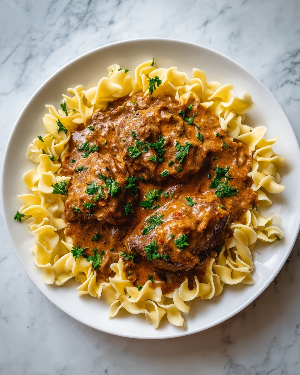 A close-up top view of a slow cooker filled with two large pieces of meat covered in thick, smooth brown gravy sauce, with small green herb leaves sprinkled gently on top. The cooker’s black inner pot and shiny metal edges are visible, with a white marbled texture underneath. The glossy sauce reflects light, giving it a rich, creamy look. photo taken with an iphone --ar 4:5 --v 7